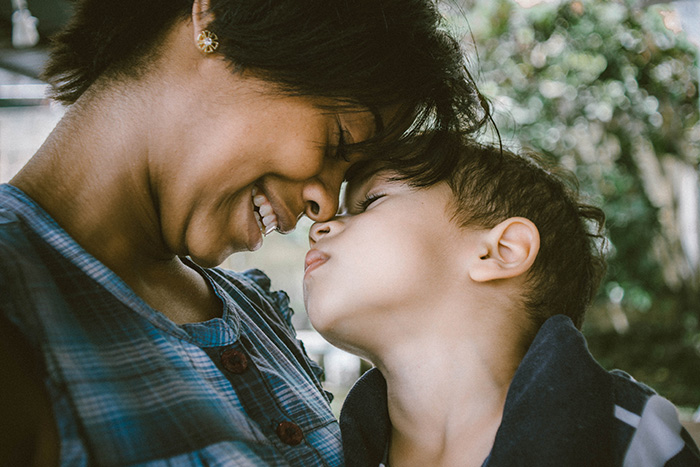 mother nuzzling small child