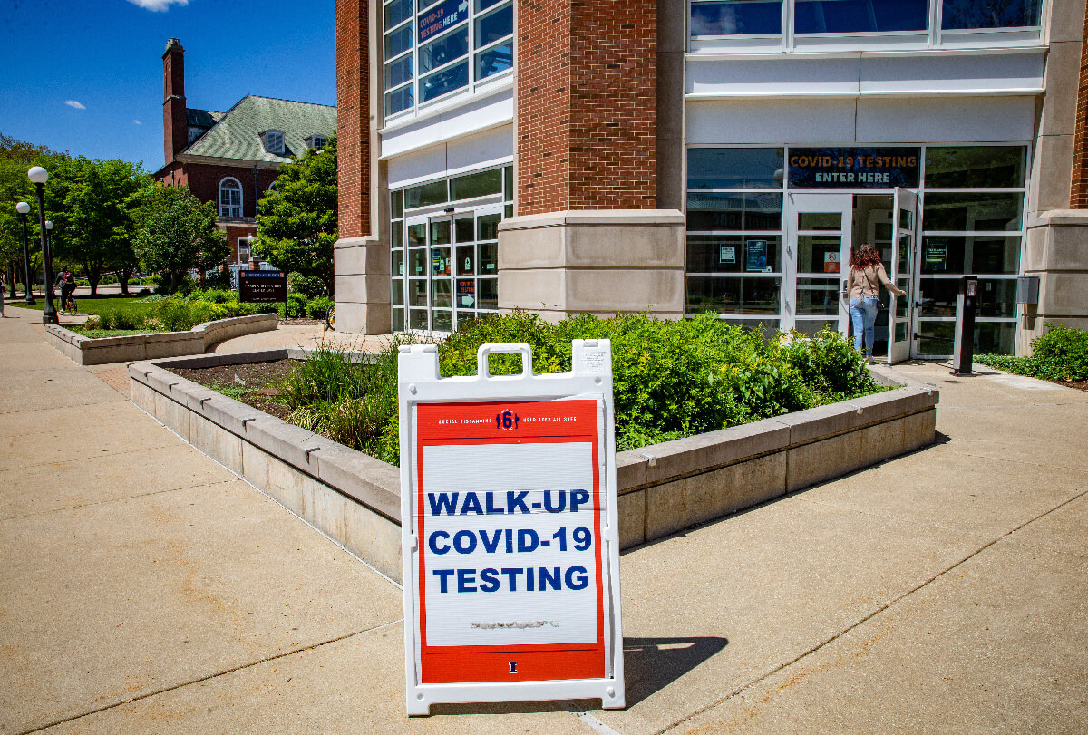 Sign in front of building reading Walk-Up COVID-19 Testing